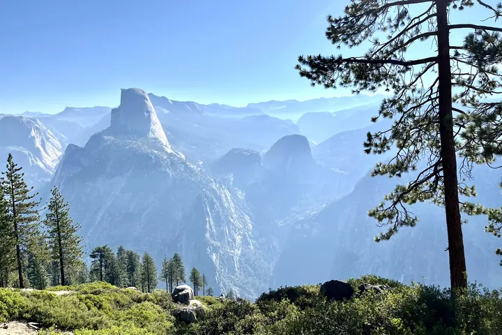 A wide granite valley with a domed summit and ranges fading into the distance.